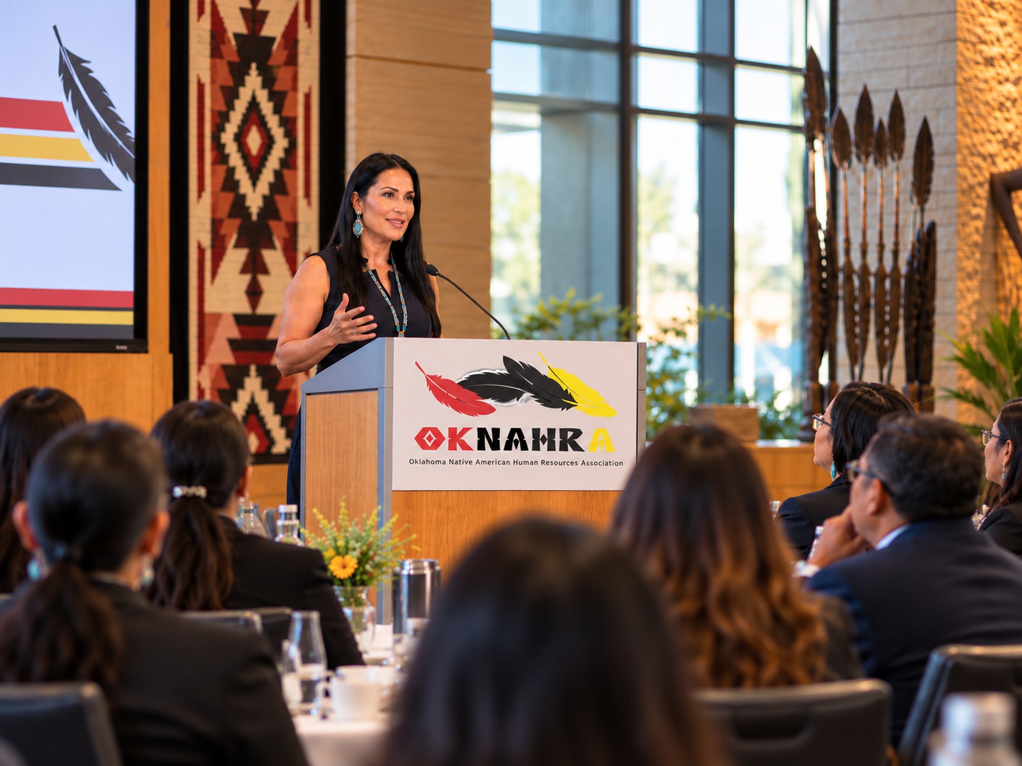Speaker addressing members at an OKNAHRA event